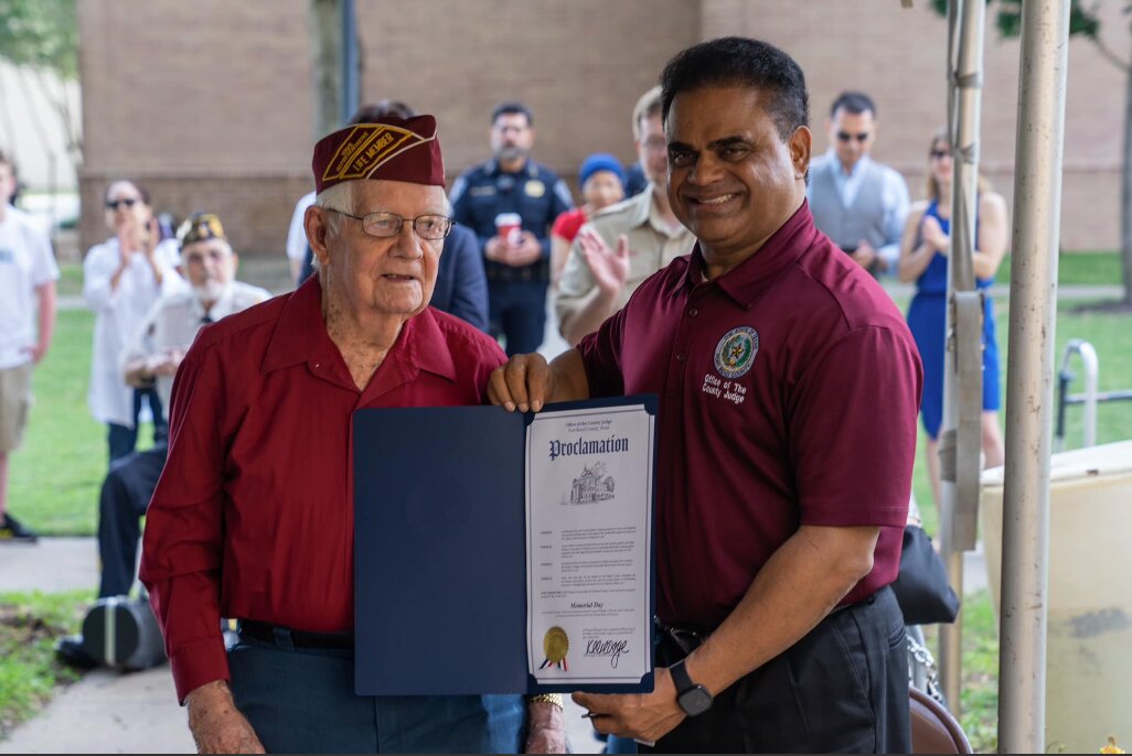 Veteran Robert J. Fagan accepts a proclamation from Fort Bend County Judge KP George.